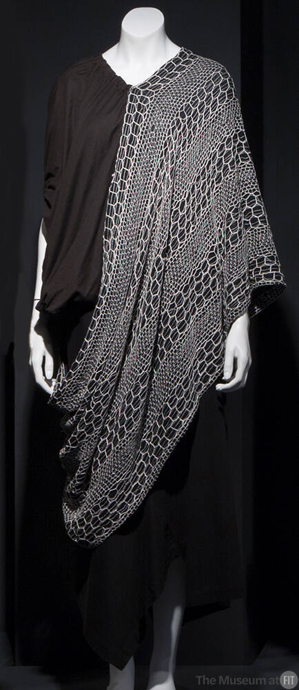 Black short sleeve top with white net poncho style overlay