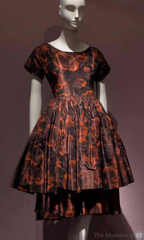 Brown and rust floral print cocktail dress with short sleeves, fitted bodice and knee length fl…