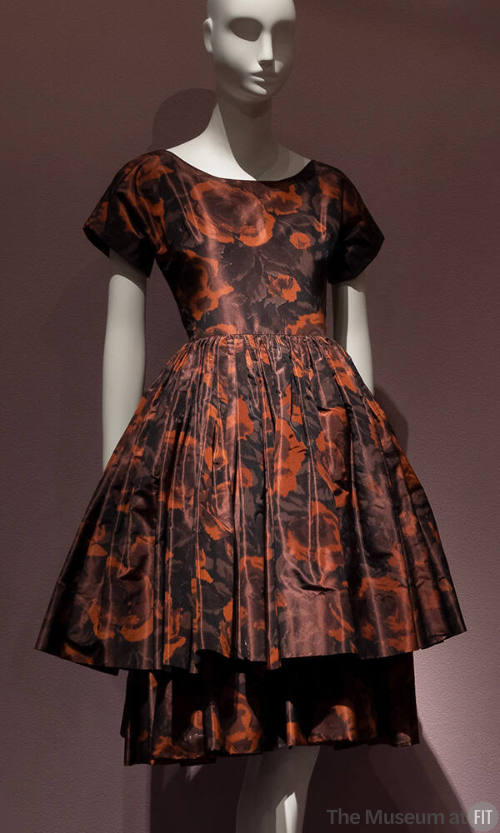 Brown and rust floral print cocktail dress with short sleeves, fitted bodice and knee length fl…