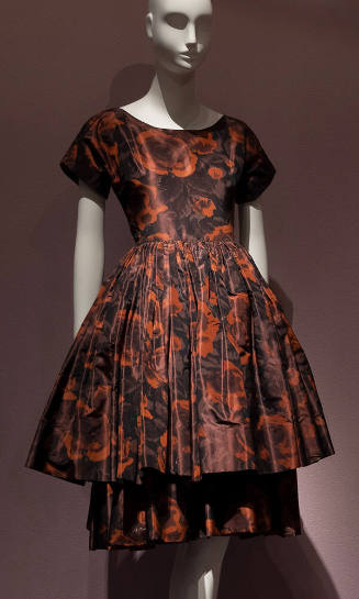 Brown and rust floral print cocktail dress with short sleeves, fitted bodice and knee length fl…