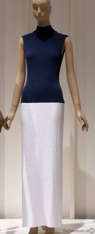 Evening sheath with navy blue mock turtleneck bodice and floor length white sequin skirt
