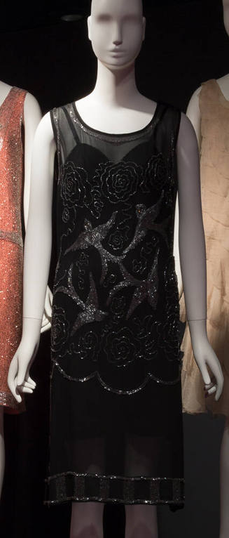 Black sleeveless knee length evening dress with silver beaded birds and floral design on bodice