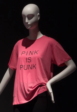 Pink short sleeve t-shirt with black text reading “Pink is Punk” at center front
