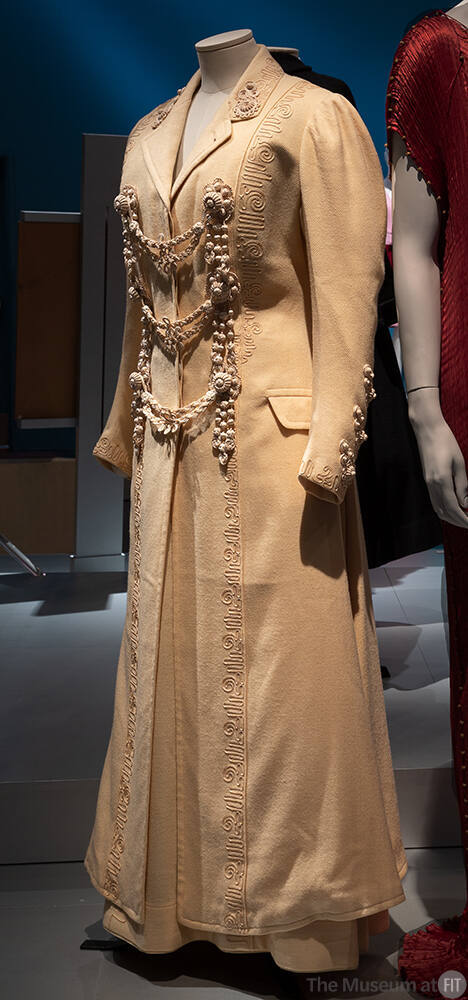 Off-white wool floor length coat and skirt with passementerie trim and three swag frog closures…