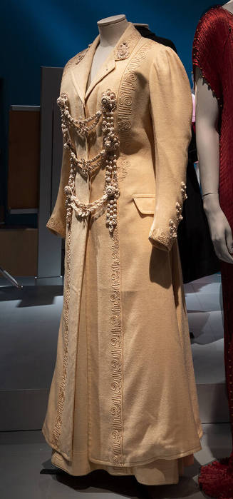 Off-white wool floor length coat and skirt with passementerie trim and three swag frog closures…
