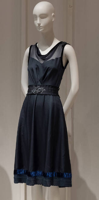 Blue sleeveless below-the-knee dress with sheer anf velvet trimmed neckline, belt with rhinesto…