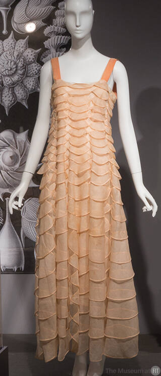Floor length evening dress of pink overlapping semi-circles with pink camisole shoulder straps