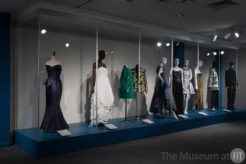 Installation view of gowns and ensembles in the rear gallery of Asian Americans in New York Fashion: Design, Labor, Innovation.