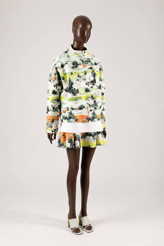 Dress, motorcycle style jacket, and top ensemble in Korean landscape print in shades of green, …