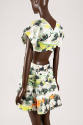 Short sleeve dress with Korean landscape print in shades of green, orange, and black; open, cut…