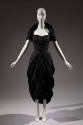 Knee length black strapless dress with peg skirt and matching shouder shrug