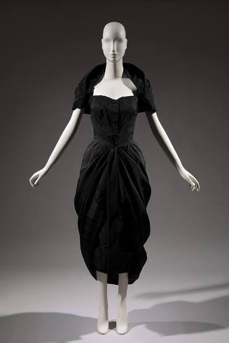 Knee length black strapless dress with peg skirt and matching shouder shrug