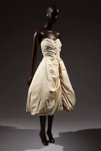 Cream strapless evening dress with covered buttons down center front and calf length bubble hem