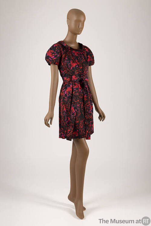 Red, pink and black abstract swirl printed dress with short sleeves, self belt and above the kn…