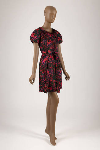 Red, pink and black abstract swirl printed dress with short sleeves, self belt and above the kn…