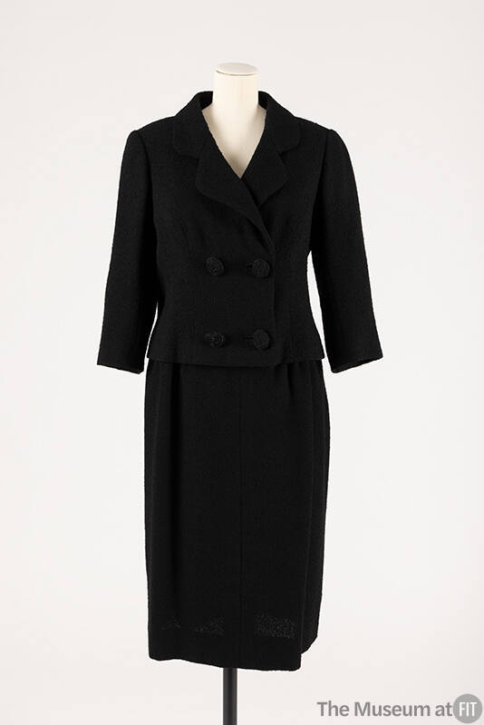 Black double breasted four button suit with ¾ sleeves and matching straight skirt