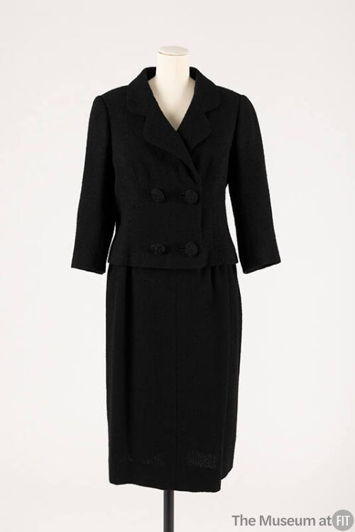 Black double breasted four button suit with ¾ sleeves and matching straight skirt
