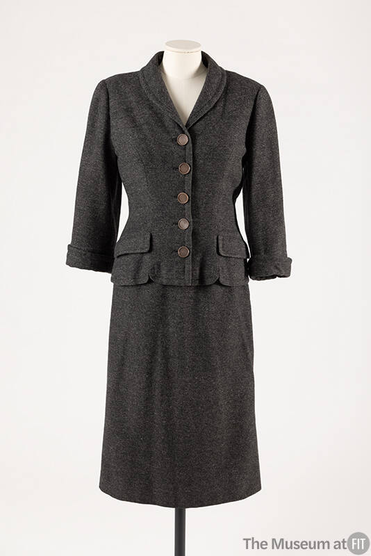 Dark grey suit with button front jacket, flap pockets and calf length straight skirt