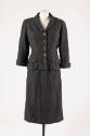 Dark grey suit with button front jacket, flap pockets and calf length straight skirt