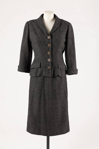 Dark grey suit with button front jacket, flap pockets and calf length straight skirt