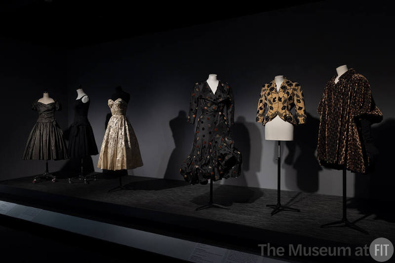 Dior + Balenciaga, Left to right: 82.208.9 (grey dress), 71.213.25 (black dress), 75.86.5 (strapless evening dress), 86.142.5 (polka dot dress), 68.151.1 (yellow and black jacket), 86.142.3 (evening coat) 