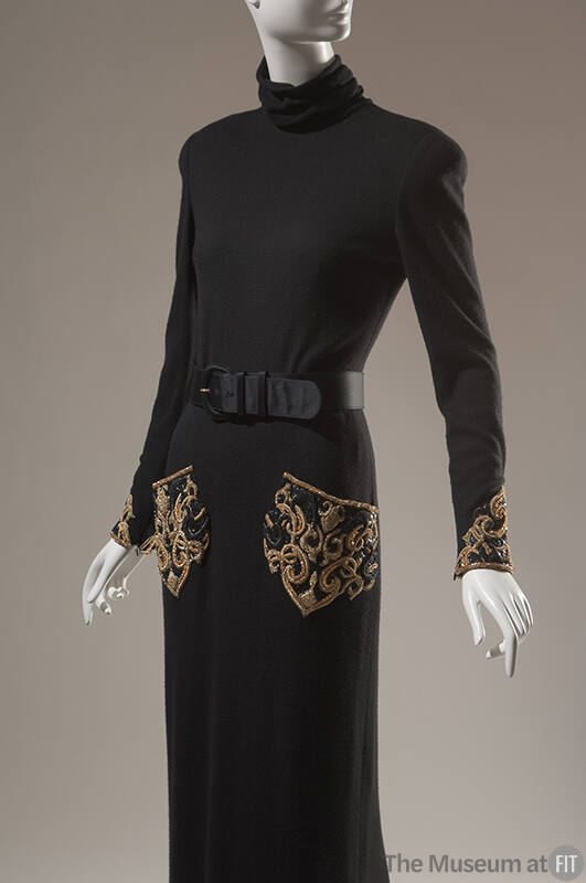 Detail of black long sleeve turtle neck dress with gold thread and beaded pockets and cuffs