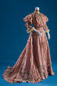 Pink two-piece dress with mono-bosom bodice, ¾ flounced sleeves and matching floor length skirt…