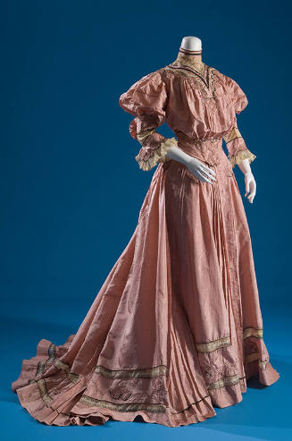 Pink two-piece dress with mono-bosom bodice, ¾ flounced sleeves and matching floor length skirt…