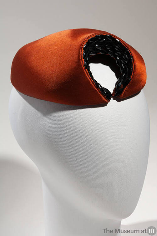 Rust brown circular hat with crescent of black beads