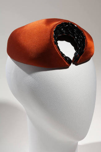 Rust brown circular hat with crescent of black beads