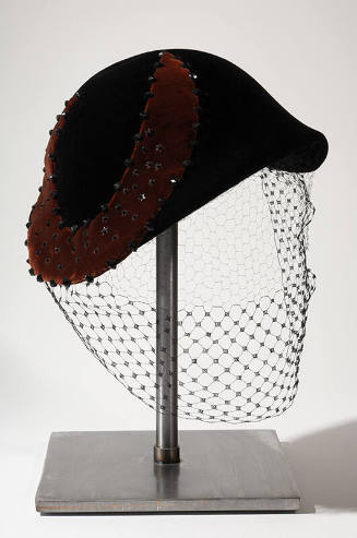 Black velvet calot, close fitting hat with large beaded purple velvet crescent appliqué; face v…