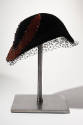Black velvet calot, close fitting hat with large beaded purple velvet crescent appliqué; face v…