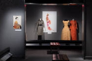 Designing Women exhibition installation view of a portrait on the left wall and three dressed m…