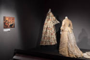 Designing Women exhibition installation view of an image on the left wall and two mannequins in…