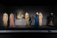 Designing Women exhibition installation view of six dressed mannequins and a sepia tone photogr…
