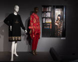 Designing Women exhibition installation view of two mannequins in a black dress and red ensembl…