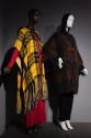 Designing Women exhibition installation view of two mannequins in a yellow and black plaid ponc…