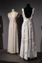 Designing Women exhibition installation view of two mannequins in white floor length evening dr…
