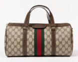 Beige satchel with brown pigskin handles, zipper top, and green and red stripe webbing decorati…