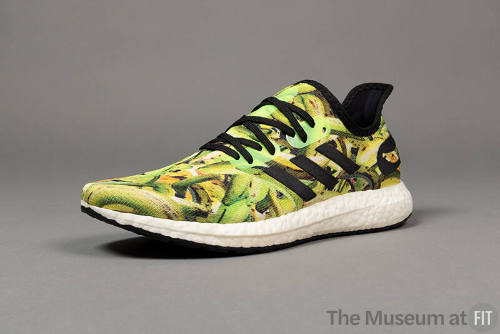 Green and yellow plantain print sneaker with black laces, trim and white soles