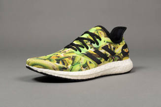 Green and yellow plantain print sneaker with black laces, trim and white soles