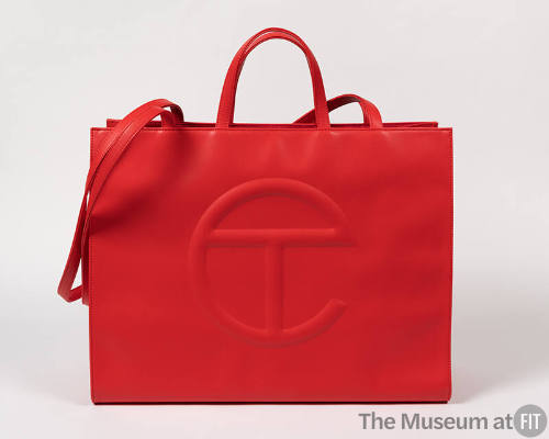 Red polyester tote bag with handles and shoulder strap