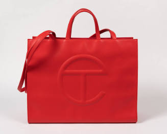 Red polyester tote bag with handles and shoulder strap