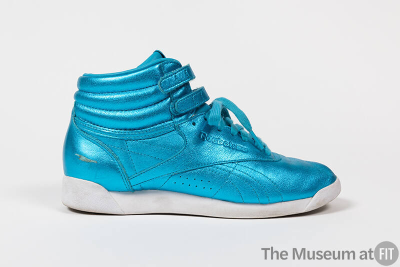 Metallic blue hightop sneaker with double velcro strap ankle closure, white sole and Reebok log…