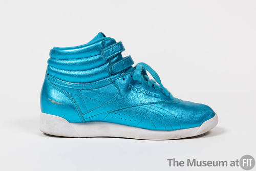 Metallic blue hightop sneaker with double velcro strap ankle closure, white sole and Reebok log…