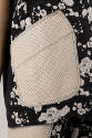 Detail view of black and off-white jacket showing off-white patch pocket with black stitching a…
