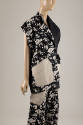 ¾ view of black with off-white splatter print jacket with off-white patch pockets and matching …