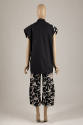 Back view of black and off-white splatter print set showing entirely black back of jacket