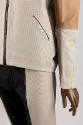 Detail view of black, off-white and tan colorblocked set showing mixed fabrics of jacket and pa…