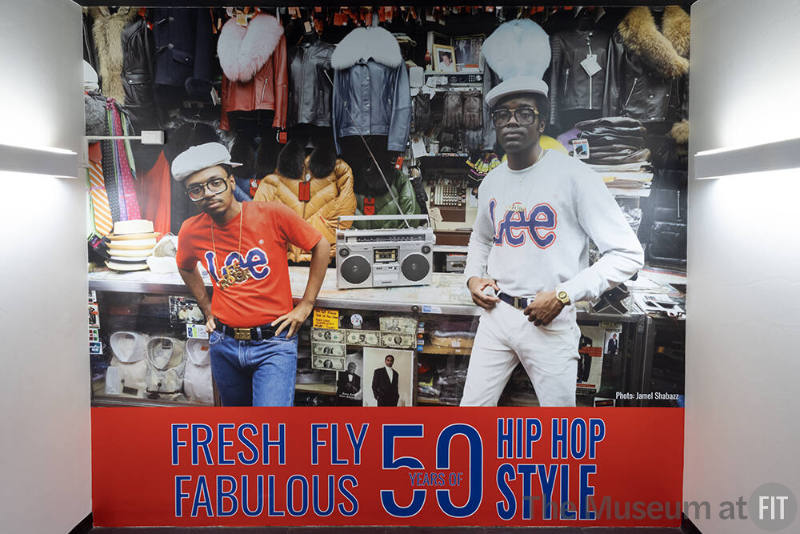 Hip Hop Style exhibition photo of two men in Lee logo shirts and blue text “Fresh, Fly, and Fab…